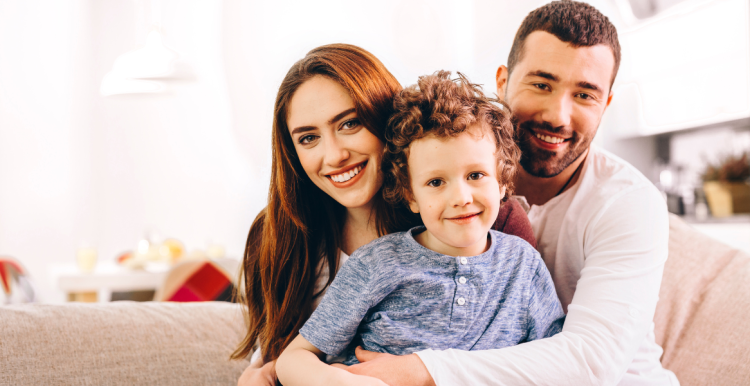 parents smiling with their son