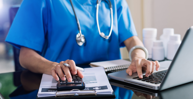 Doctor in uniform on the laptop