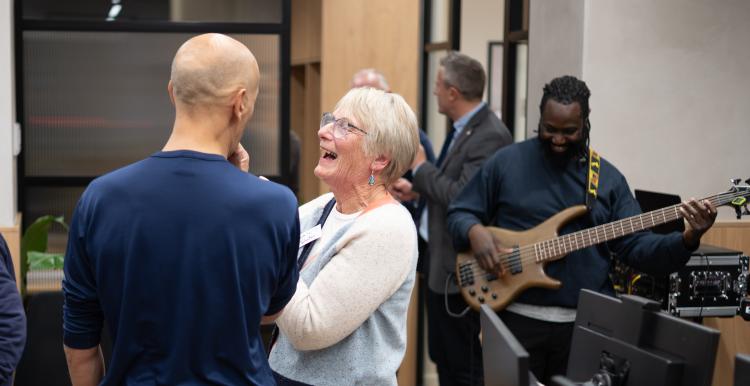 Attendees at Healthwatch Wandsworth Assembly with band Assorted Beat playing in the background