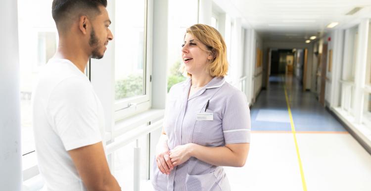 Young man chats with nurse about his health care