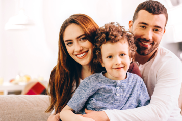 parents smiling with their son