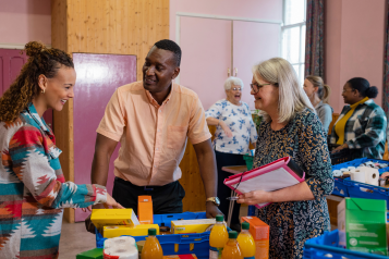 People at a food bank helping with surplus food and donations