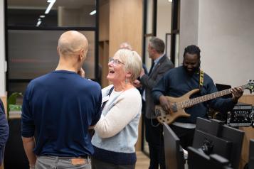 Attendees at Healthwatch Wandsworth Assembly with band Assorted Beat playing in the background