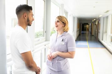 Young man chats with nurse about his health care