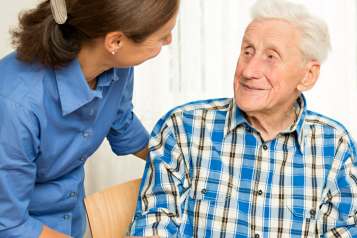 Man looking from seat at female carer